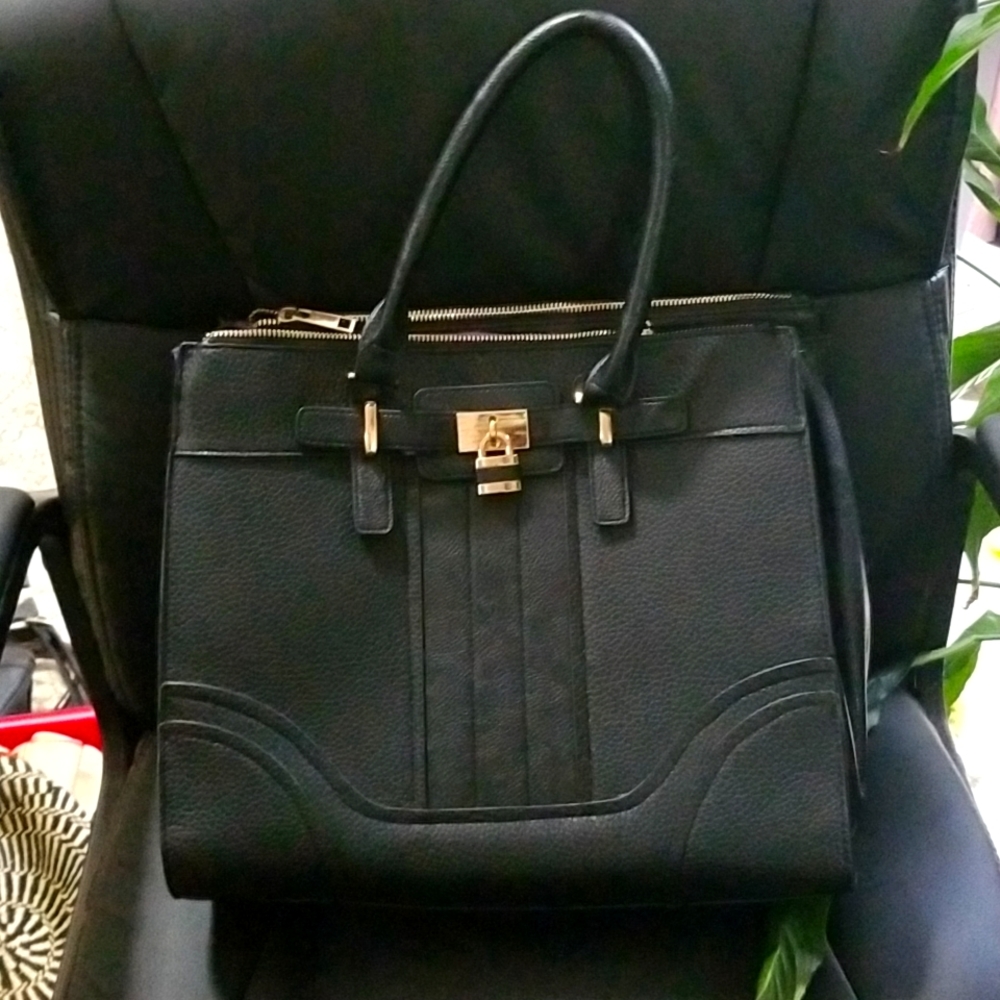 Sondra Roberts black purse with purple lining.
